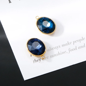 Detail of 18K gold plated oval dark blue crystal charms for DIY jewelry making