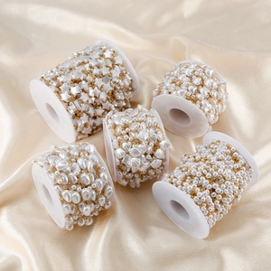 Macro detail of star and heart pearl bead chains on spools for DIY jewelry making