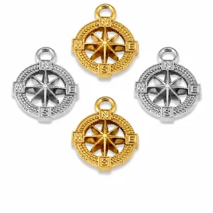 Dettaglio dei ciondoli bussola vichinga in oro e argento con incisione delle lettere cardinali