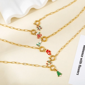 Detailed view of gold stainless steel necklace with Christmas enamel charms and pendants