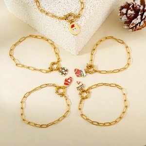 Detail of Christmas gold paperclip bracelet set with festive enamel charms and OT toggle clasp