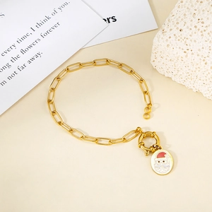 Detail of gold chain bracelet with OT clasp and Santa Claus enamel pendant for Christmas