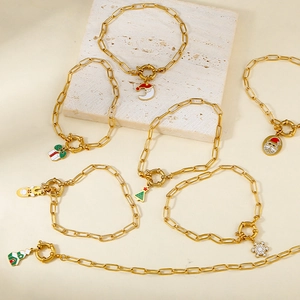 Golden paperclip bracelet with Christmas charms like Santa and tree, OT clasp design