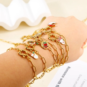 Golden Christmas bracelet featuring reindeer and bell charms with OT toggle clasp