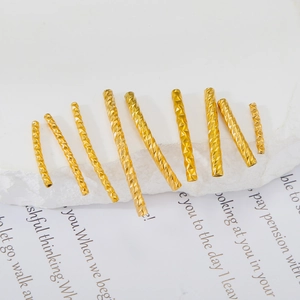 Close-up of diamond-cut gold stainless steel tube beads for DIY jewelry making