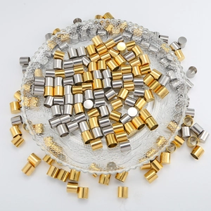 Polished gold and silver stainless steel end caps for DIY jewelry making in a glass dish