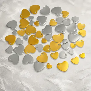 Macro shot of gold and silver heart-shaped stainless steel charms for DIY jewelry making