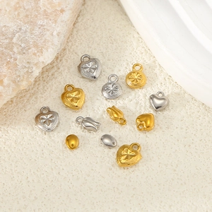 Detailed view of DIY heart and star steel pendants on a textured stone aesthetic background