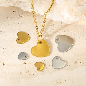 Detailed macro view of heart-shaped DIY jewelry charms in gold and silver matte finishes