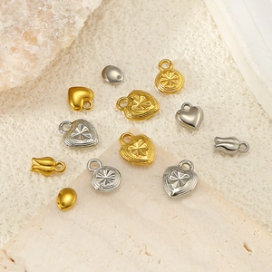 Detailed macro view of mixed gold and silver stainless steel heart and tulip charms