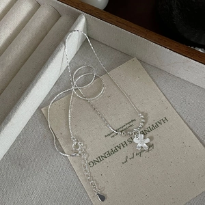 Detailed macro view of S925 sterling silver flower pendant necklace on display card