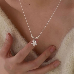 Elegant s925 silver flower necklace with beads worn on a warm beige knit sweater