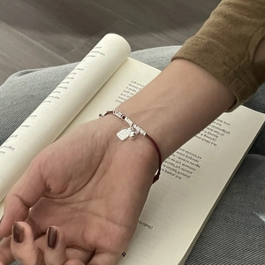 Handcrafted S925 sterling silver red woven bracelet with square pendant worn on wrist