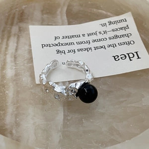 Macro detail of silver lava texture ring featuring a polished black onyx sphere