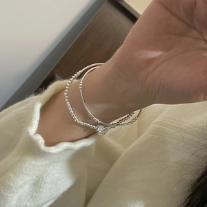 Elegant S925 sterling silver layered bracelet set with beads on a knit sweater background