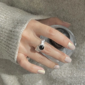 Macro view of S925 silver ring with irregular hammered texture and black onyx gemstone