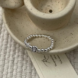 Detailed macro view of S925 sterling silver beaded ring with heart engraved square pendant