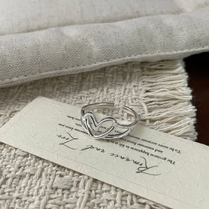 Close-up of S925 sterling silver hollow double heart ring with polished mirror finish
