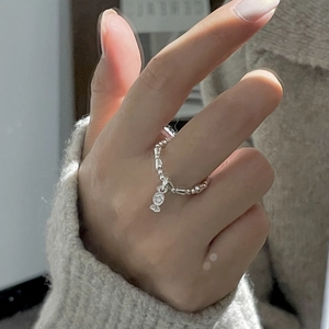 Detail of S925 sterling silver beaded ring featuring a candy pendant with star engraving