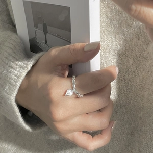 Detail of S925 sterling silver beaded ring with vintage heart pendant on model hand