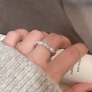 Close-up of S925 sterling silver twisted woven ring on hand with a minimalist style