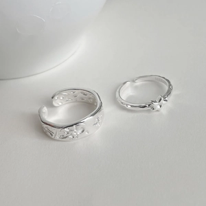 Detailed macro view of S925 sterling silver stamp and celestial texture on star rings