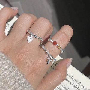 Detail of S925 sterling silver beaded rings featuring heart and character charms