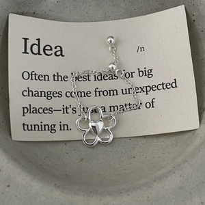 Detailed macro view of S925 sterling silver flower ring with adjustable chain and heart core