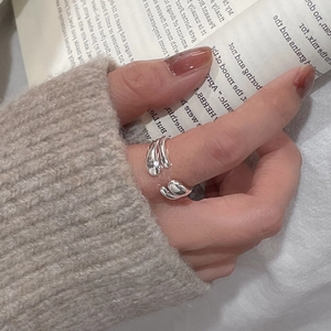 Detail of minimalist 925 sterling silver double-layer open ring with liquid metal texture