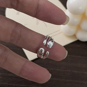 Detailed close-up of S925 sterling silver layered open ring with polished liquid metal finish