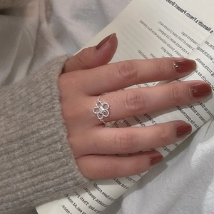 Detail of adjustable S925 sterling silver flower ring with delicate micro-set diamond inlay