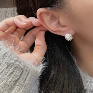 Detailed view of silver S925 sterling silver sphere stud earrings with textured finish
