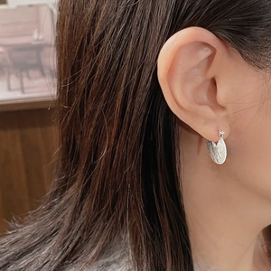Minimalist S925 sterling silver hoop earrings with brushed oval pendant on female model