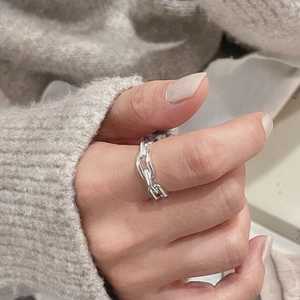 Close-up of S925 sterling silver chain link ring on hand with knit background