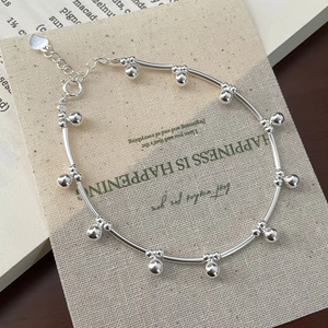 Detail of S925 sterling silver beaded bracelet with heart charm and adjustable chain link