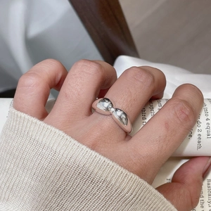 Macro shot of minimalist S925 sterling silver ring with polished irregular wide surface