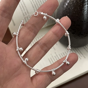 Minimalist S925 sterling silver beaded tube bracelet for women on a lifestyle background