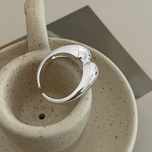 Close-up of S925 sterling silver liquid heart ring with polished mirror finish detail