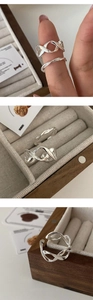Macro shot of twisted minimalist 925 sterling silver rings in elegant jewelry box