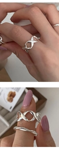 Detail of interlocking infinity 925 sterling silver ring with twisted rope texture