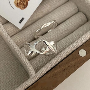 Minimalist 925 sterling silver interwoven stackable rings in a luxury jewelry box