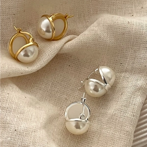 Elegant 925 sterling silver pearl hoop earrings in gold and silver finish on linen