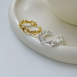 Detail showing gold and silver 925 sterling silver heart-shaped chain open rings
