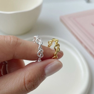 Macro view of woven chain design on minimalist 925 sterling silver rings in silver and gold