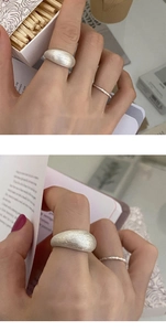 Detail of minimalist S925 sterling silver wide band ring with brushed matte finish texture