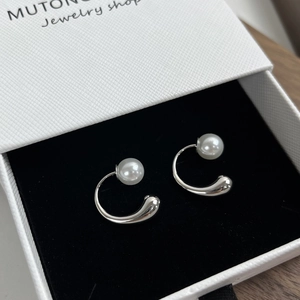 Close-up of S925 sterling silver drop pearl earrings presented in a jewelry box