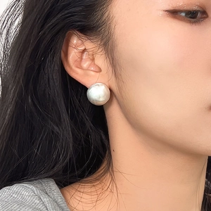 Minimalist S925 sterling silver brushed round ball stud earrings worn by a model