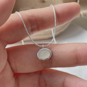 Detailed close-up of S925 silver necklace with an elegant oval white chalcedony pendant