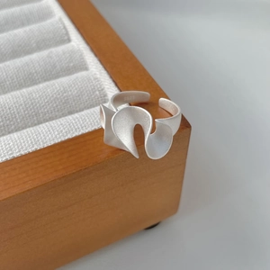 Macro detail of S925 sterling silver ring featuring a matte finish and irregular wave design