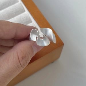 Detailed macro view of S925 sterling silver ring with irregular wavy texture